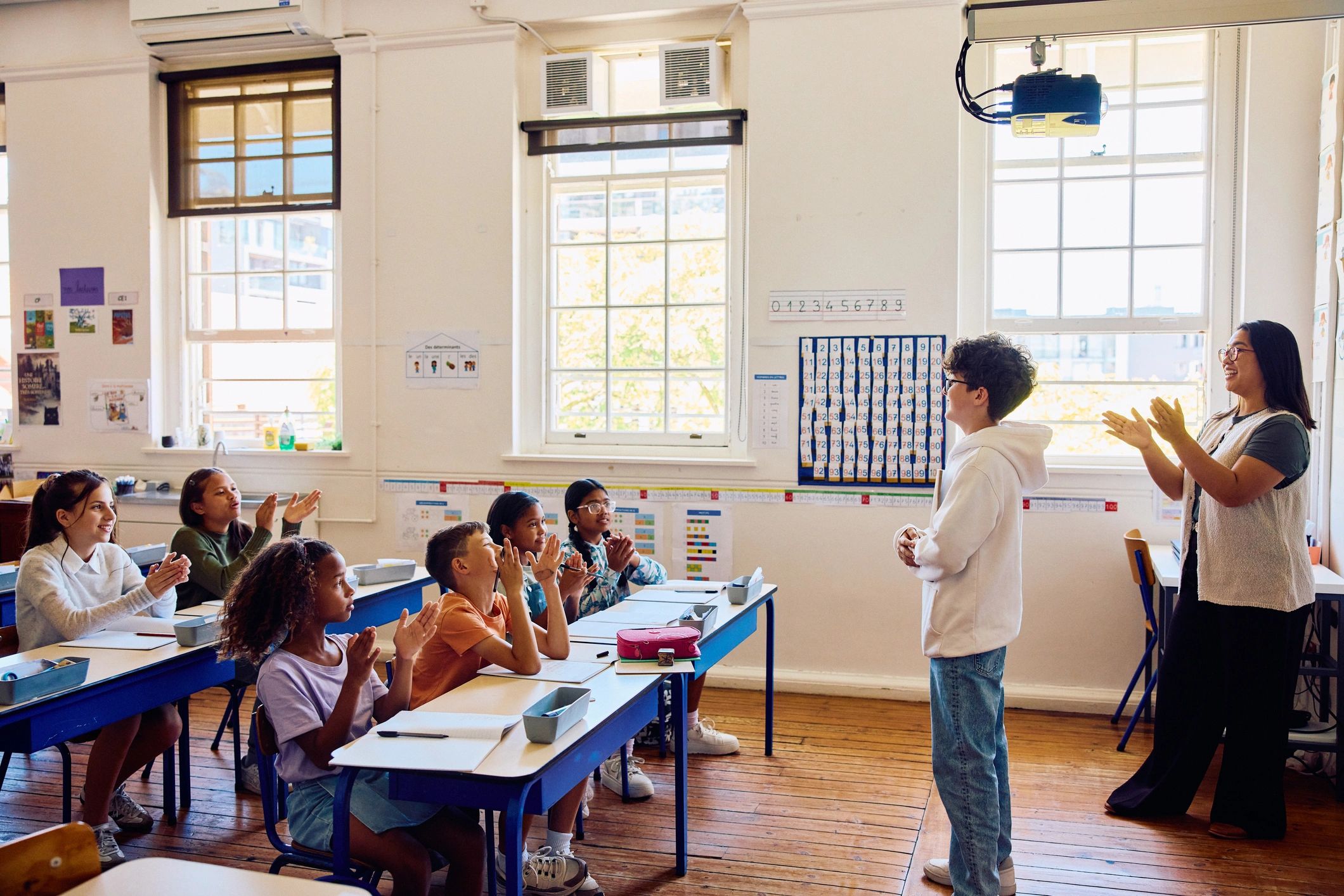 Student presenting at the front of a classroom